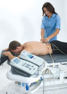 Therapist applying electrodes to patient